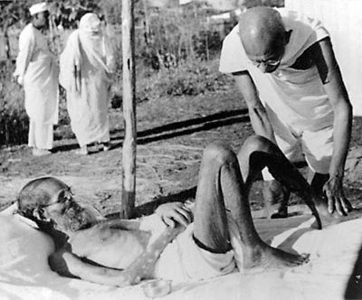 Gandhiji tending Parchure Shastri, a leprosy patient, at Sevagram
