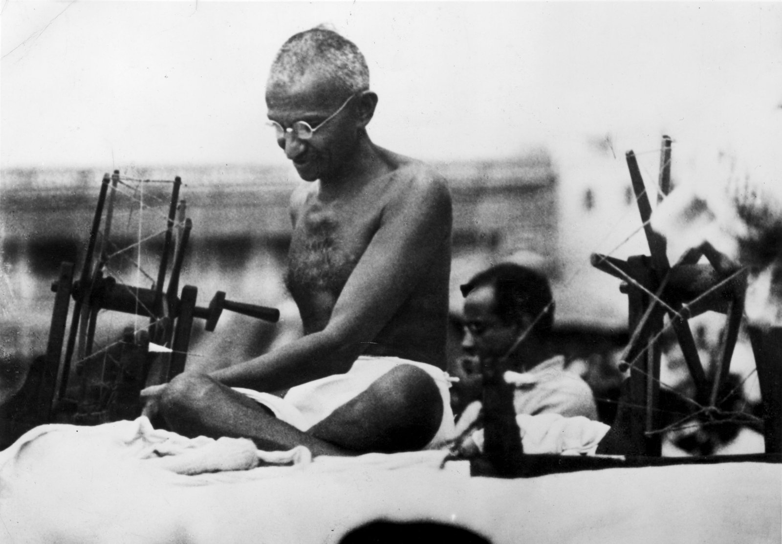 Gandhiji spinning at a charkha during a khadi demonstration in Mirzapur, 1925