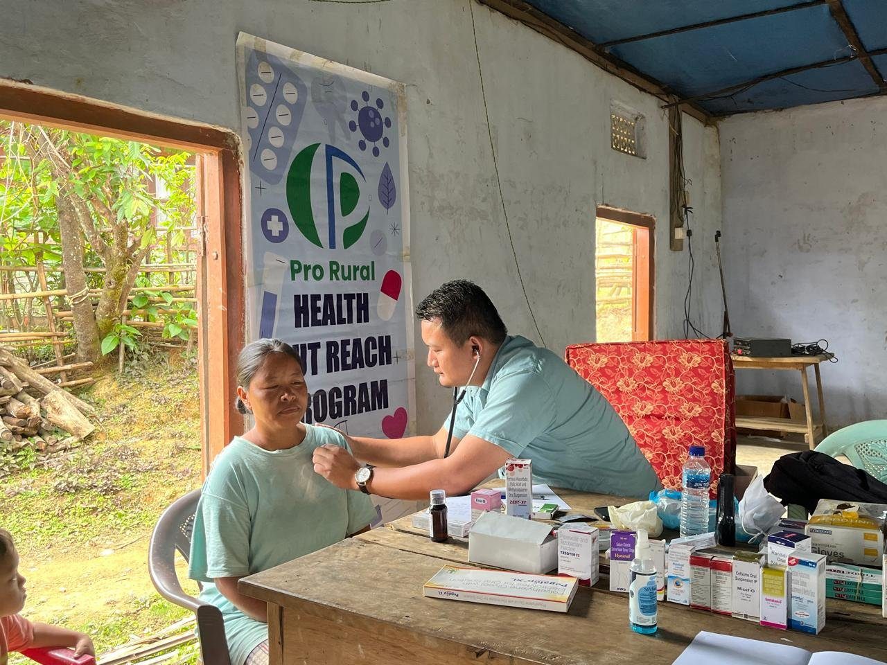 A doctor examines a village woman at a PRO RURAL health outreach camp